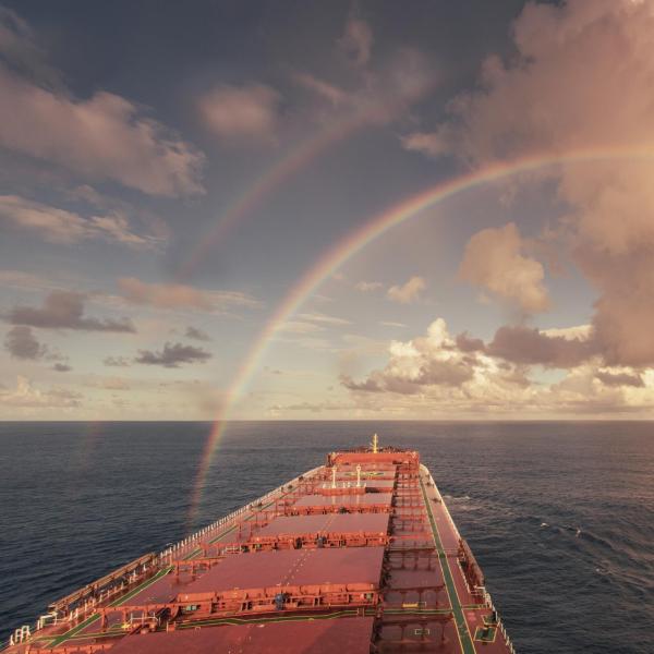 ship on the sea with a rainbow on the sky